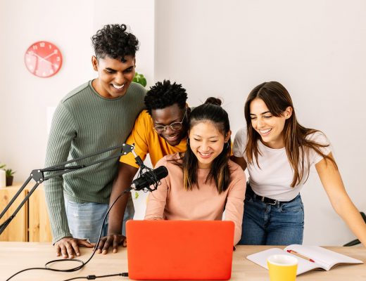 Happy young student friends working recording radio podcast at home office